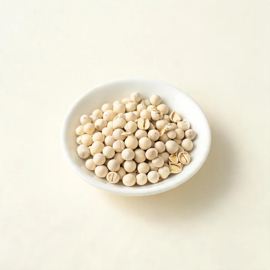 Dried Bai Jie Zi seed arranged in a shallow bowl
