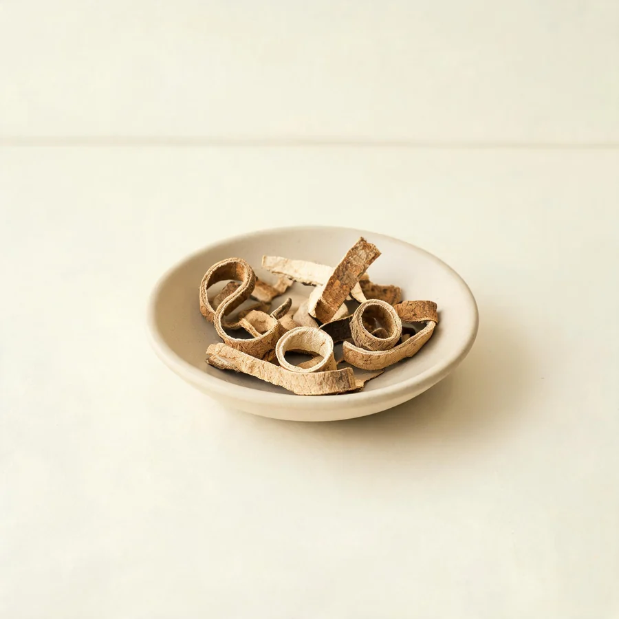 Dried Di Gu Pi root bark arranged in a shallow bowl