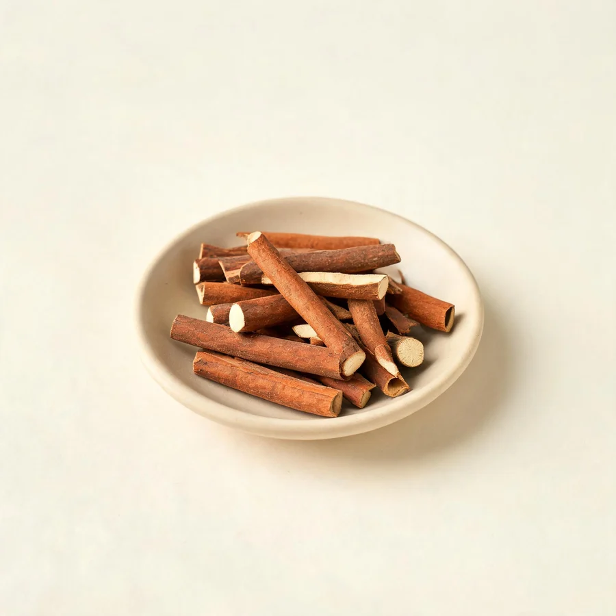 Dried Gui Zhi young twig arranged in a shallow bowl