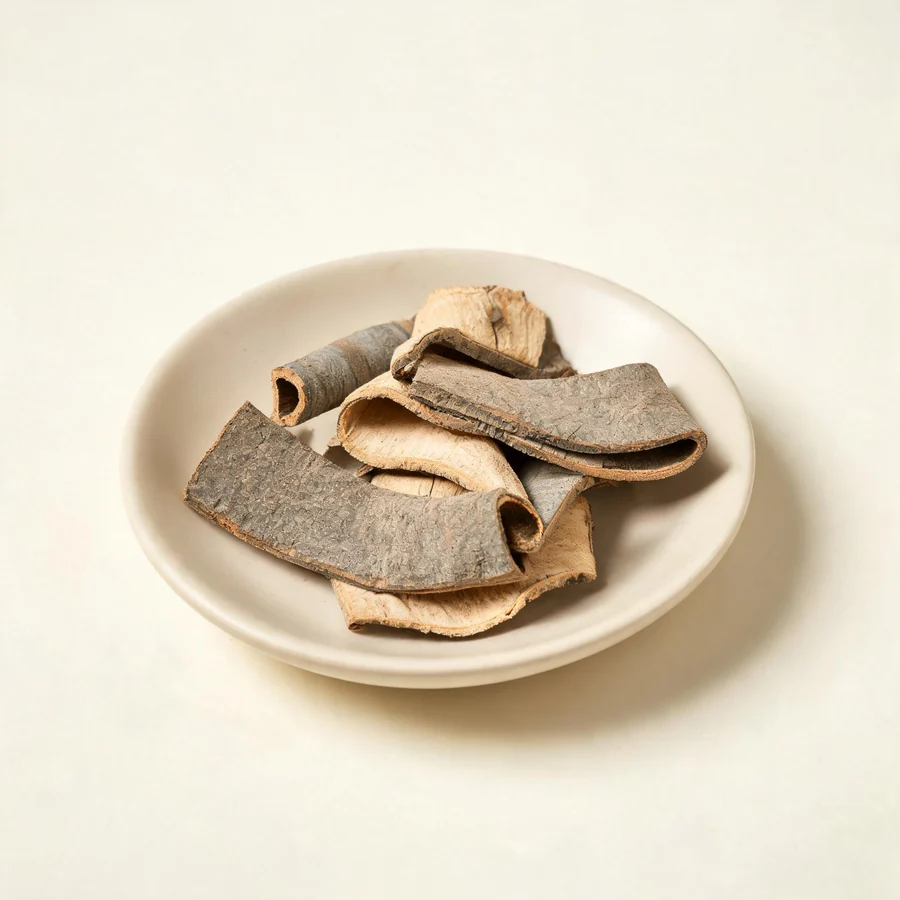 Dried Qin Pi bark arranged in a shallow bowl