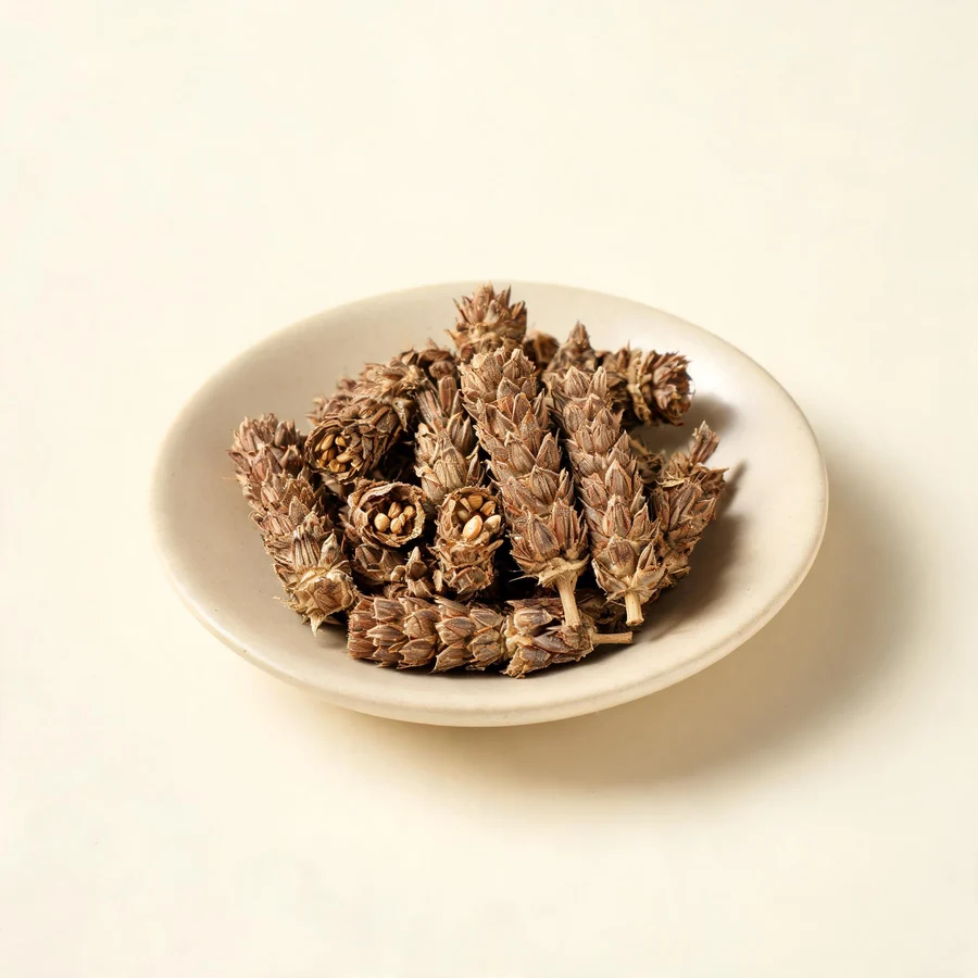 Dried Xia Ku Cao flower spike arranged in a shallow bowl