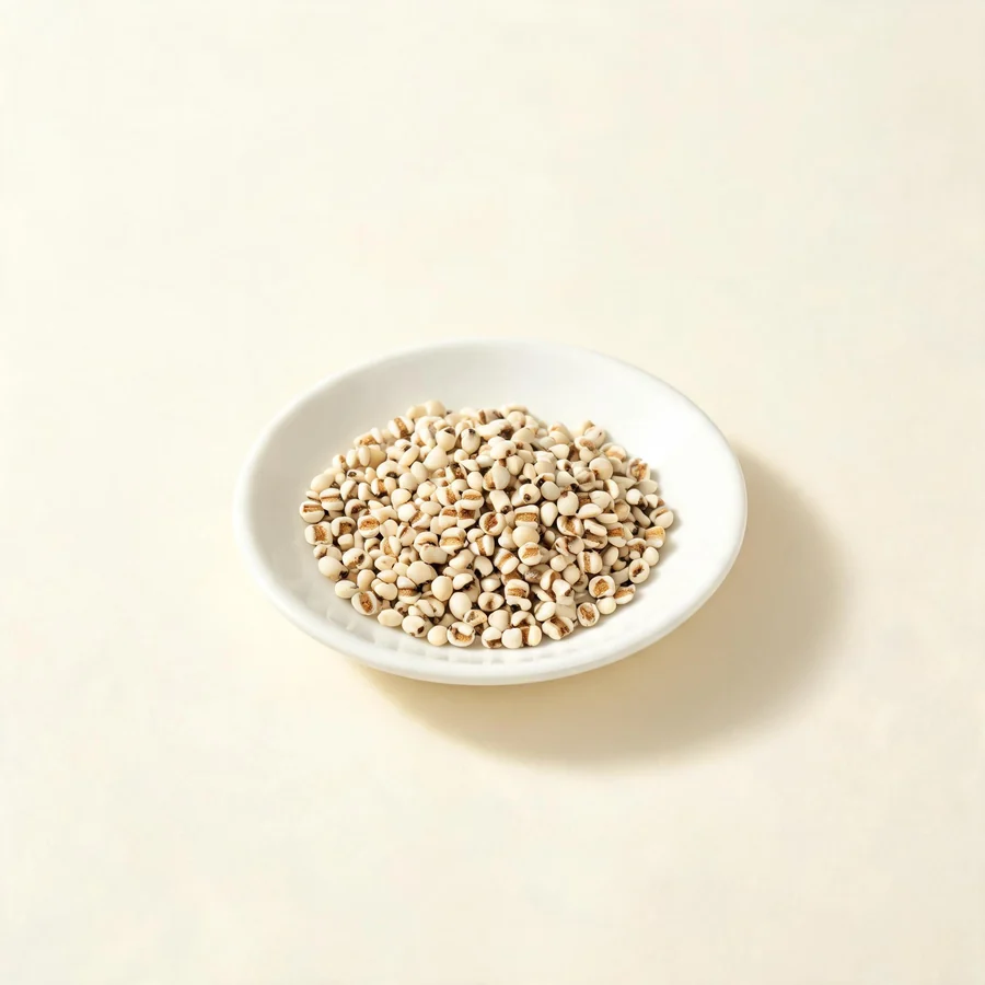 Dried Yi Yi Ren seed arranged in a shallow bowl