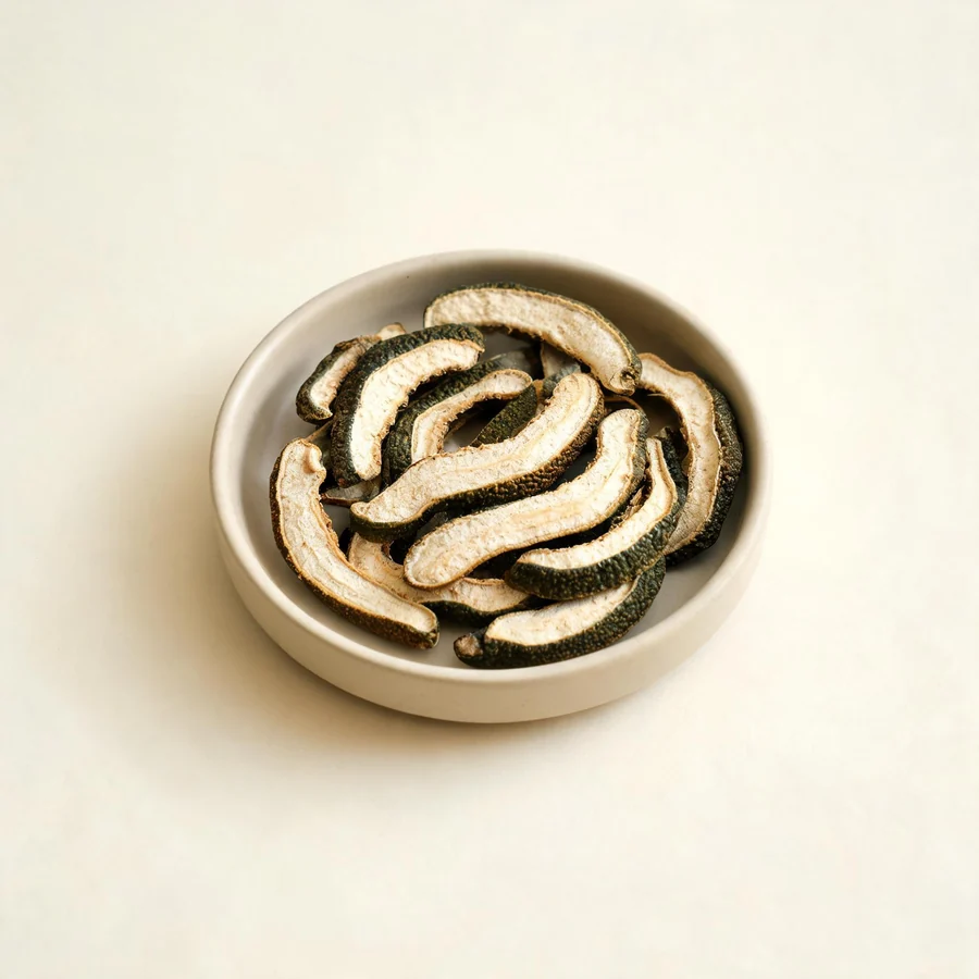 Dried Zhi Ke nearly mature fruit arranged in a shallow bowl