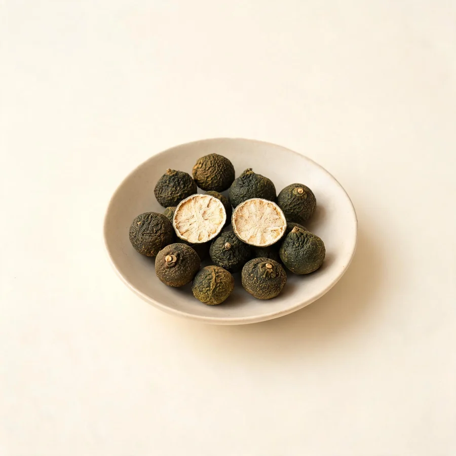 Dried Zhi Shi immature fruit arranged in a shallow bowl